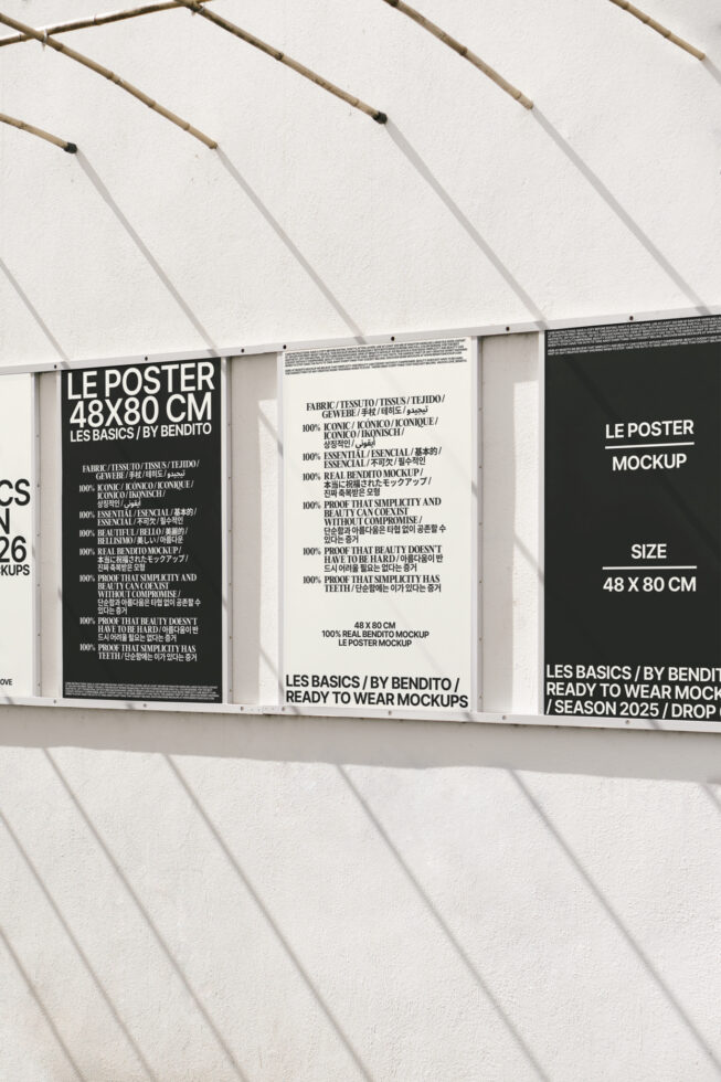 Outdoor poster mockup display with bold text design on a white wall shadows cast over posters ideal for mockup presentation digital graphic design.