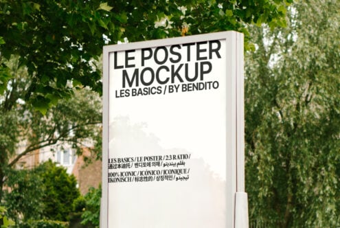 Outdoor poster mockup display surrounded by green foliage ideal for showcasing design work or advertisement templates for designers and marketers