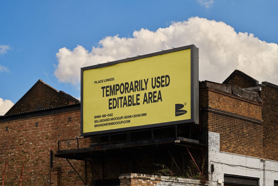 Outdoor billboard mockup on an industrial building with clear blue sky. Editable space for designers graphic template branding presentation.