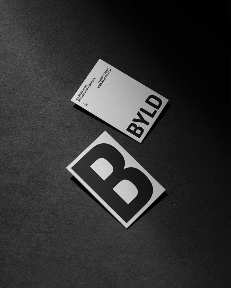 Minimalist business card mockup with bold typography on a dark background ideal for designers showcasing branding graphics templates and modern design elements.