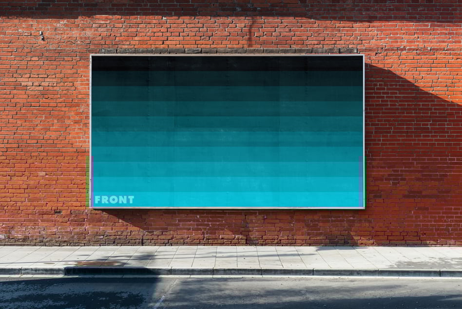 Brick wall with a large vertical blue sign for mockup display. Ideal for showcasing posters or graphic designs. Urban outdoor setting, shadowed street.