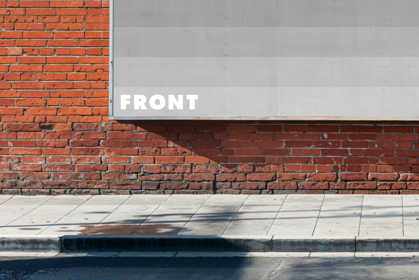 Urban mockup of a blank billboard on a red brick wall alongside a sidewalk perfect for showcasing poster designs and advertising templates for designers
