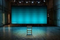 Industrial warehouse with turquoise LED screen displaying cyan gradient design