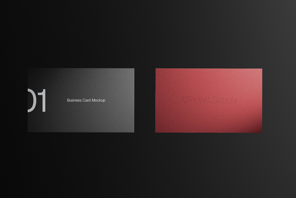 Two business cards displayed side by side, dark gray on left, coral red on right