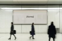 Large wall-mounted digital display mockup in modern interior setting with blurred figures walking by. Perfect for showcasing branding or advertising designs.