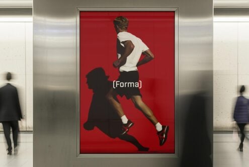 Digital poster mockup in a modern subway showing a running athlete on a vibrant red background ideal for designers looking for dynamic graphics.