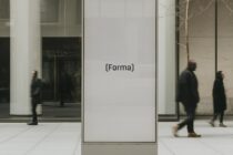 Blank gray display window in urban storefront with blurred pedestrians