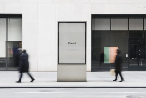 Urban street billboard mockup with pedestrians blurred in motion. Ideal for presenting ad designs or creative visual content. City setting for designers.