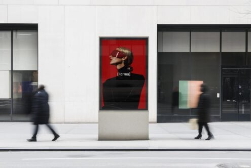 City street scene with a modern digital billboard showcasing a sleek fashion template design. Ideal for mockup presentations and creative advertising graphics.