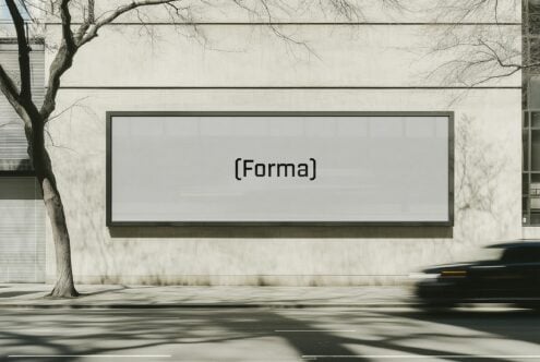 Mockup of a large billboard on a city street showcasing the text Forma. Ideal for urban design presentations and outdoor advertising templates.