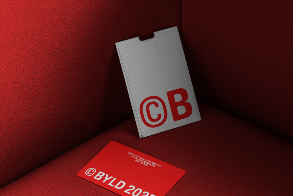 Stationery mockup showing business card with logo on deep red leather background