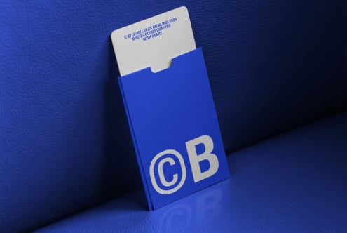 Blue cardholder with modern design and typography mockup for designers showcasing branding potential in digital assets market featuring sleek aesthetics.