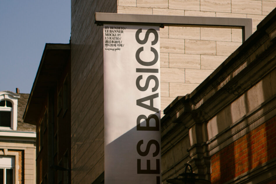 Vertical banner mockup on brick building with dark text on light background
