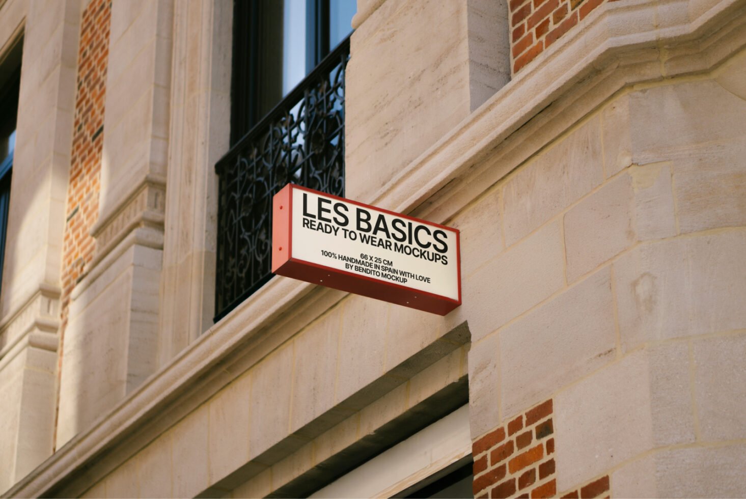 Storefront wall with Les Basics sign showcasing ready-to-wear mockups for designers. Urban setting. Keywords: mockups, design, storefront, signage.
