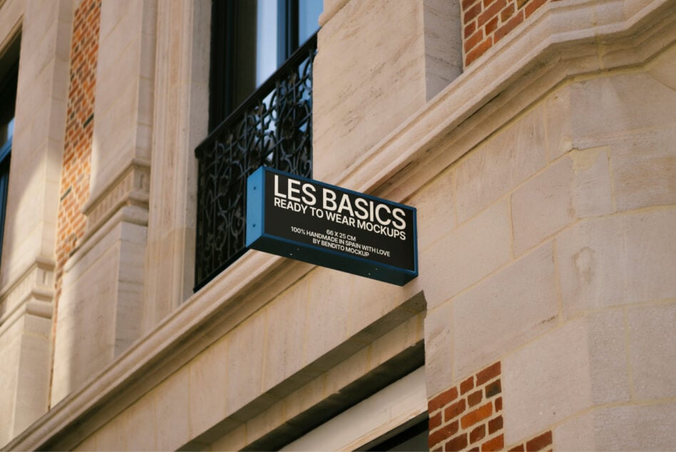 Dark blue horizontal sign mounted on building facade next to window