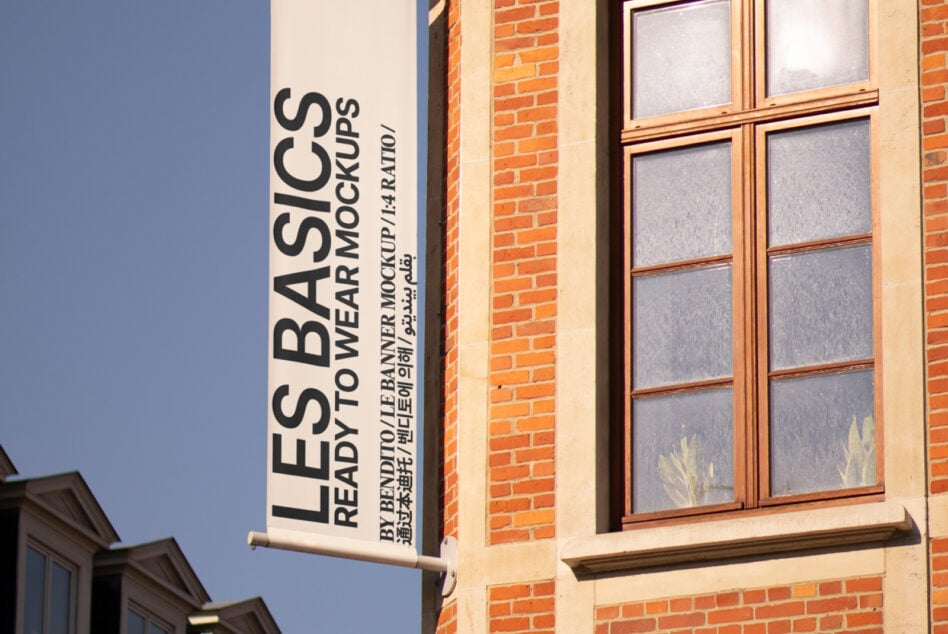 Ready-to-wear mockup light banner hanging on brick corner storefront
