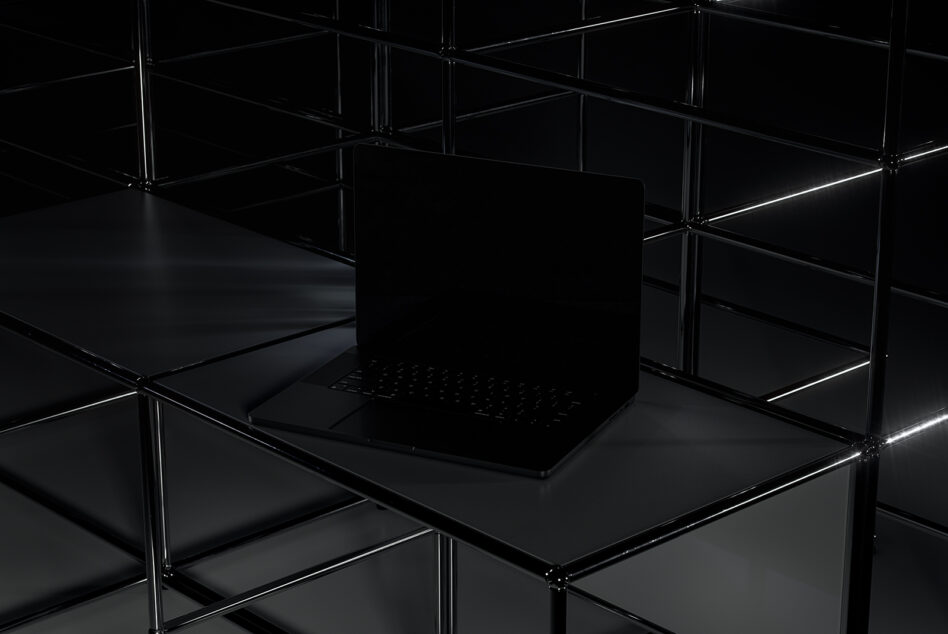 Minimalist black laptop mockup on geometric glass platform with steel framing