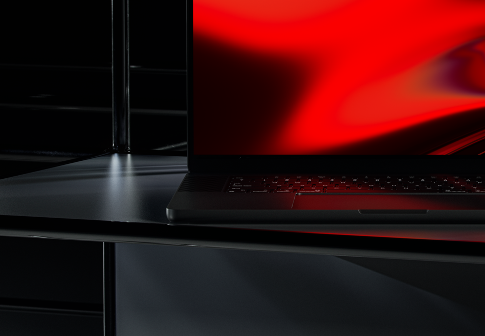 Red gaming laptop on dark desk, blurred red screen glow, sleek modern setup