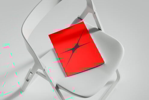 Red book on white chair mockup for designers. Minimalist cover design suitable for branding presentation. Ideal for templates and graphic design assets.