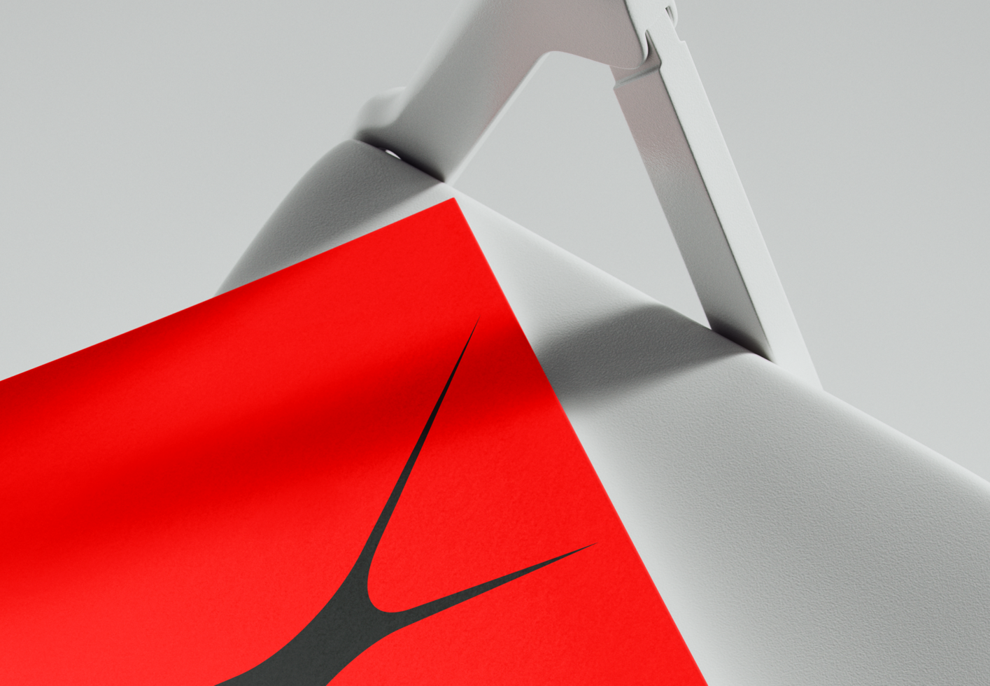 Red box with swoosh logo peeking out from white angular paper folds
