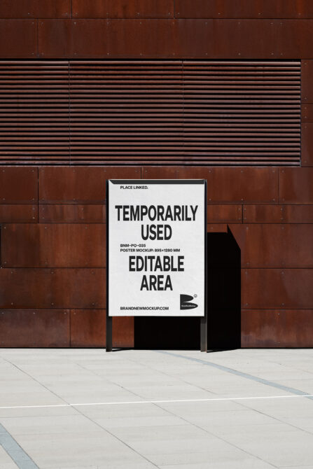 White poster mounted on industrial brick wall mockup template closeup