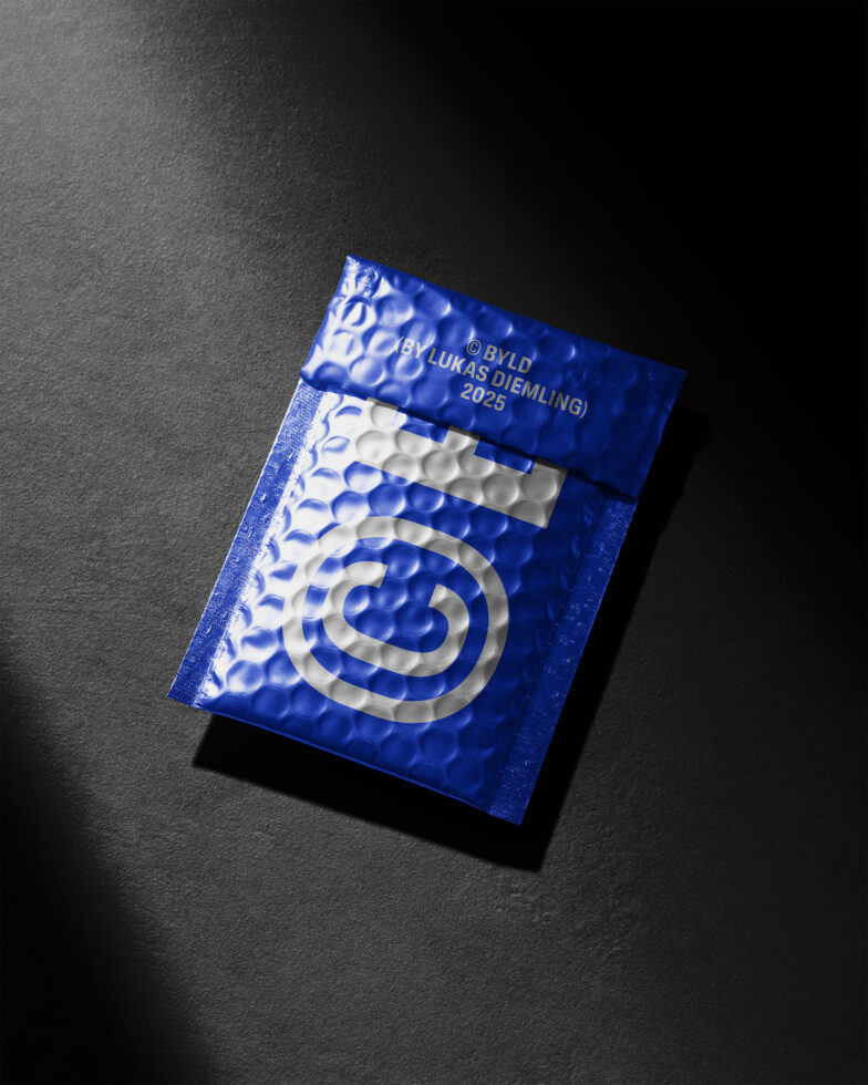 Blue textured bubble mailer with bold white logo on dark surface. Ideal for packaging design resources. Mockup for digital asset marketplace.