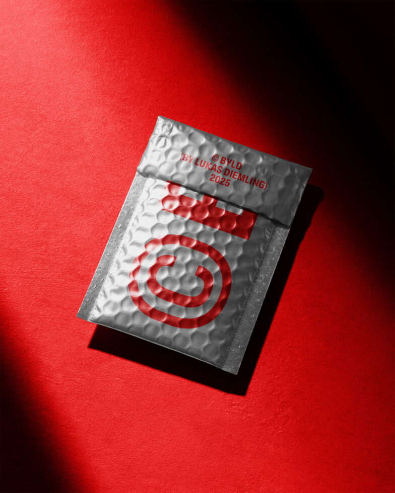 Silver bubble mailer with a red abstract design on a vibrant red background. Perfect for mockup presentations and graphic design projects.