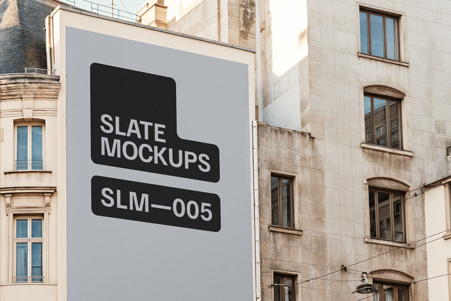Urban building facade featuring a large poster mockup Slate Mockups SLM-005 ideal for showcasing creative designs and advertising in a city environment