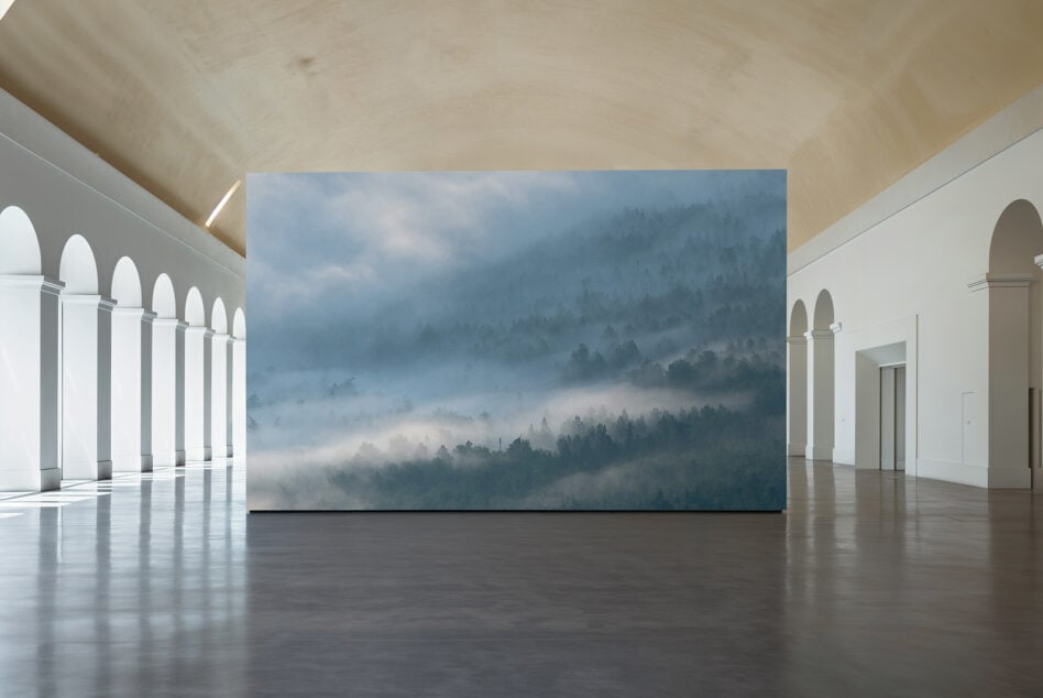 Horizontal print mockup in modern gallery space with arched columns
