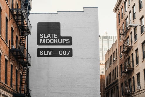 Urban wall with mockup design for Slate Mockups SLM-007 on a blank brick surface between buildings keywords mockup urban design template.