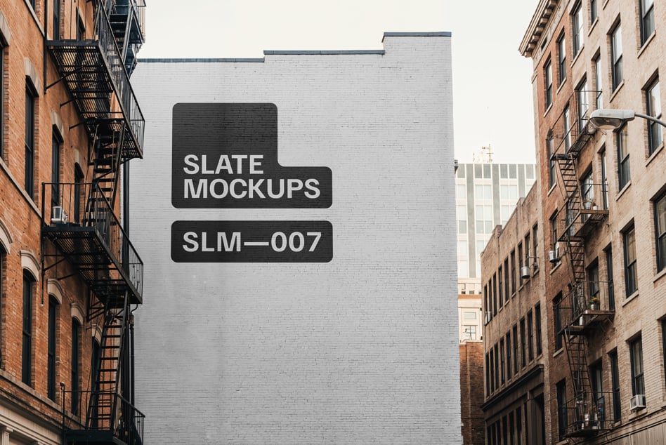 Light brick building wall with slate mockups text overlay in urban alley