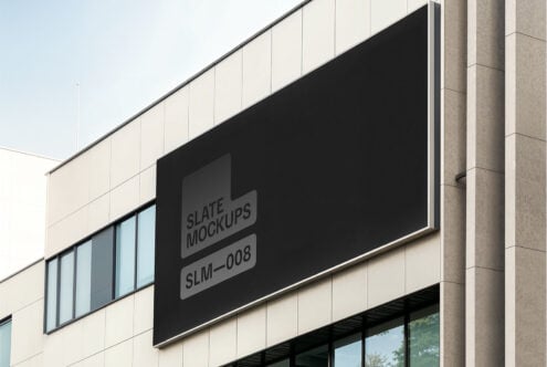 Outdoor billboard mockup on modern building facade with blank black space for advertising design. Ideal for showcasing graphics and templates.