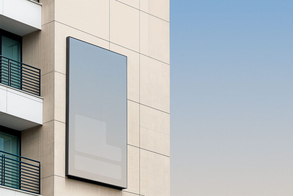 Urban facade with pale blue rectangular billboard mockup mounted on cream building