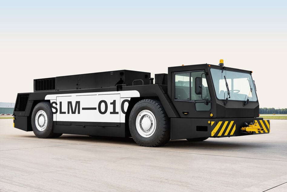 Black tug boat with white stripe side view on concrete runway