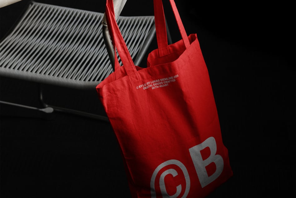 Red shopping bag with gray CB monogram, studio lighting shot