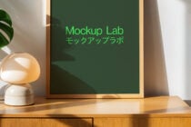 Modern frame mockup lab setup on wooden surface with lamp and green plant. Ideal for designers seeking templates or mockups for interior design projects.