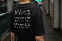 Back view of oversized black tee featuring stacked Mockup Lab text repeating