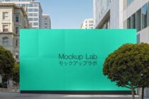 Urban building facade mockup featuring a turquoise wall with text Mockup Lab in English and Japanese ideal for branding presentation and design projects.