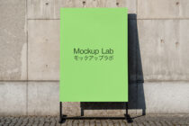 Vertical poster mockup with lime green background on concrete wall with stand