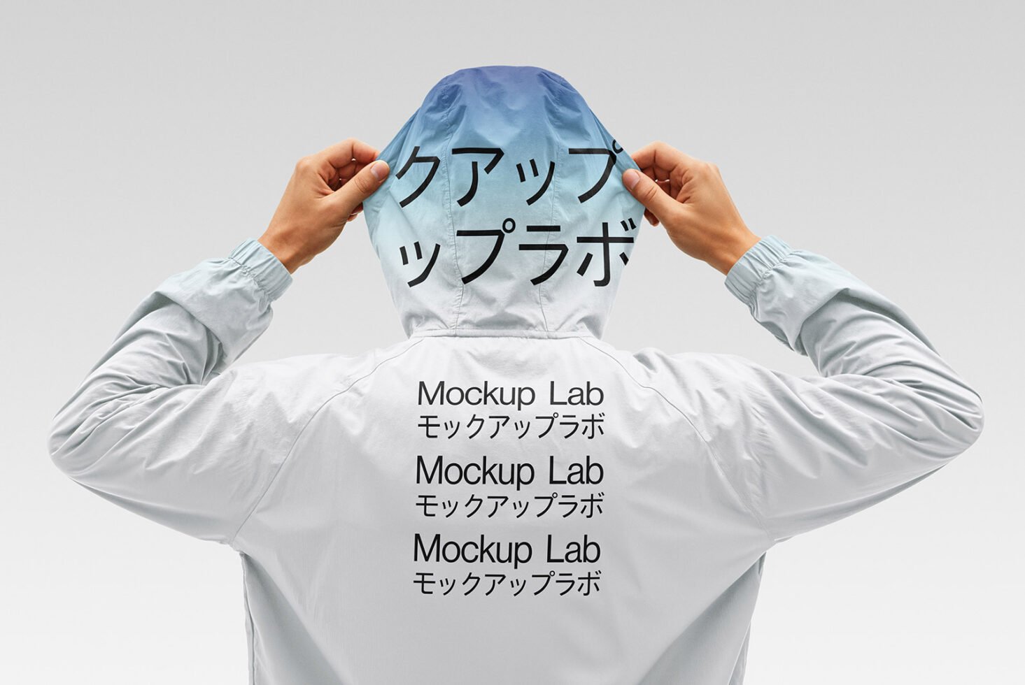 Back view of person in hooded jacket featuring Mockup Lab text in English and Japanese. Ideal for mockup design, branding assets, or graphic templates.
