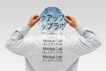 Person holding up light blue jacket with Japanese text mockup overlay on chest