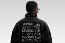 Black fleece jacket back view with white embroidered repeating text design
