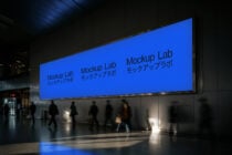Digital billboard mockup in a subway setting featuring blue screens with text Mockup Lab Japanese. Perfect for urban design presentations视觉化.