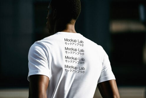 Back view of a person wearing a white t-shirt mockup displaying Mockup Lab text. Perfect for designers to showcase apparel graphics and templates.