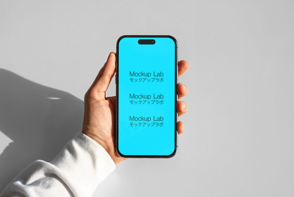 Hand holding iPhone with bright cyan screen showing repeated Mockup Lab text