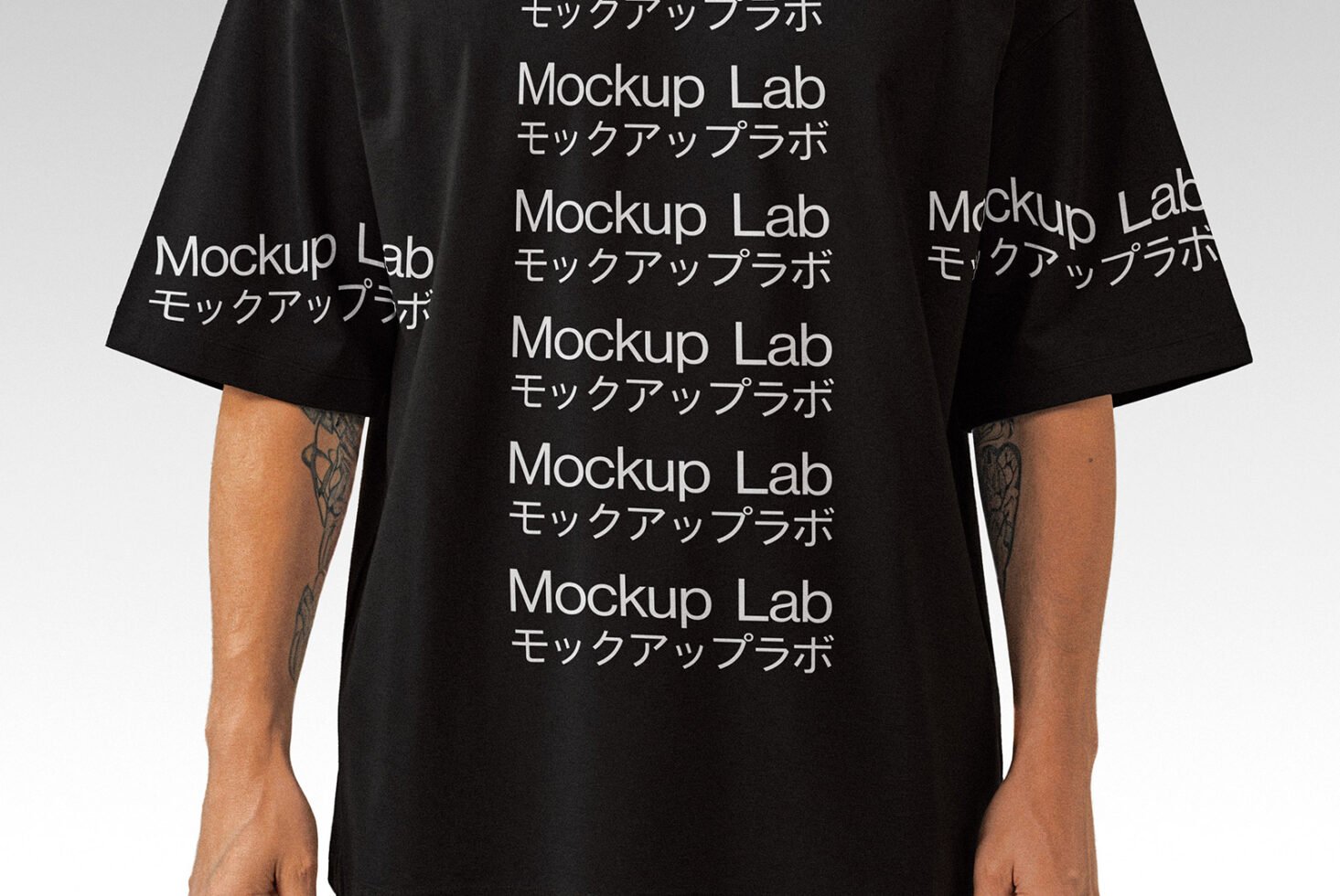 T-shirt mockup featuring a person wearing a black shirt with repeated Mockup Lab text in English and Japanese. Ideal for apparel design presentations.