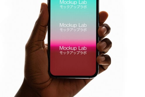 Hand holding smartphone with colorful gradient background displaying Mockup Lab text in Japanese and English. Perfect for design mockup presentations.