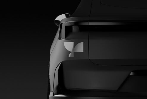 Closeup of a sleek black car rear highlighting geometric logo. Ideal for automotive mockups, graphic design assets, branding, logo presentations.