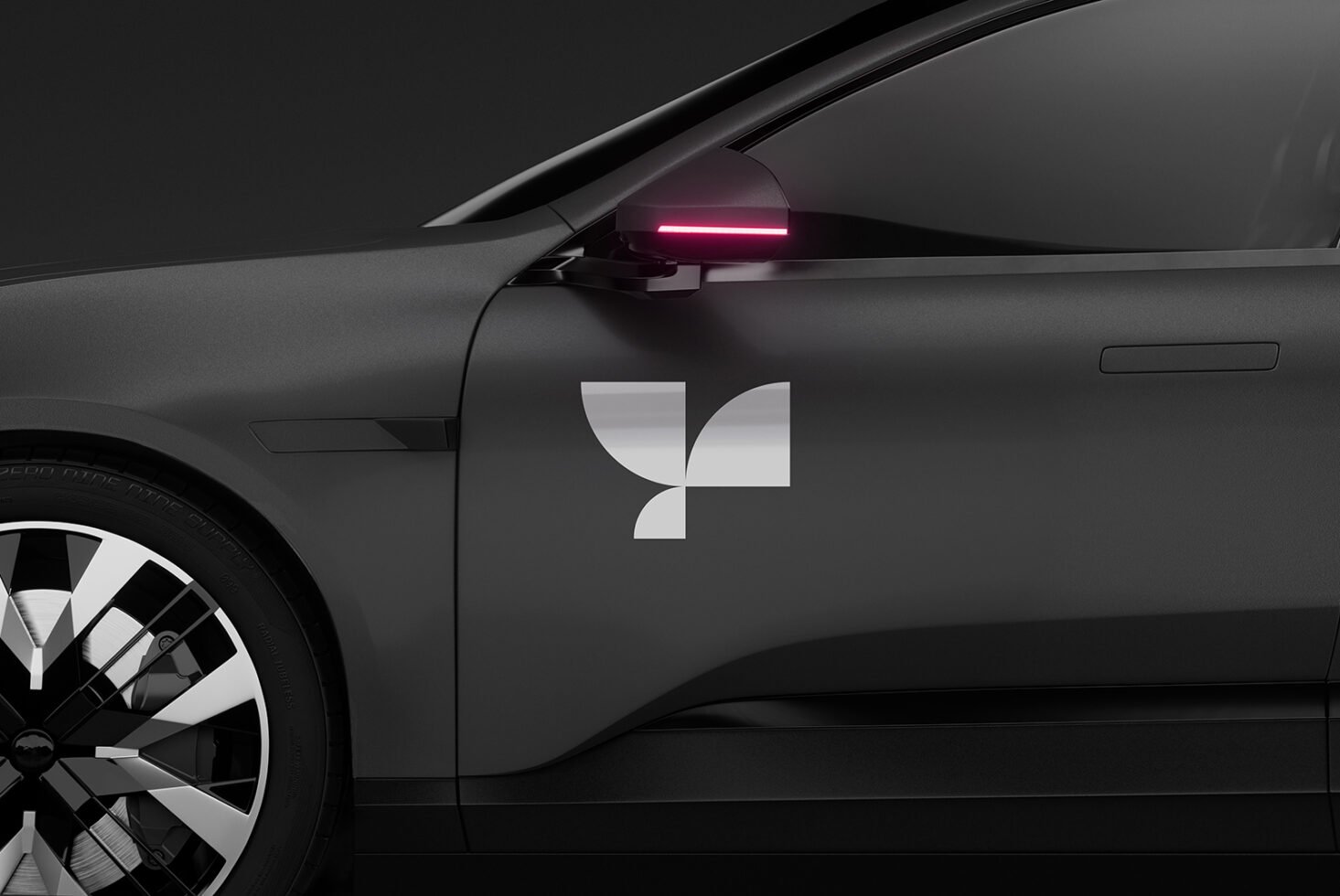 Black car side view mockup featuring a sleek modern design with a stylish logo sticker and illuminated rearview mirror perfect for branding and advertising.