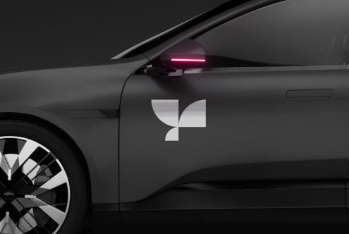Black car side view mockup featuring a sleek modern design with a stylish logo sticker and illuminated rearview mirror perfect for branding and advertising.